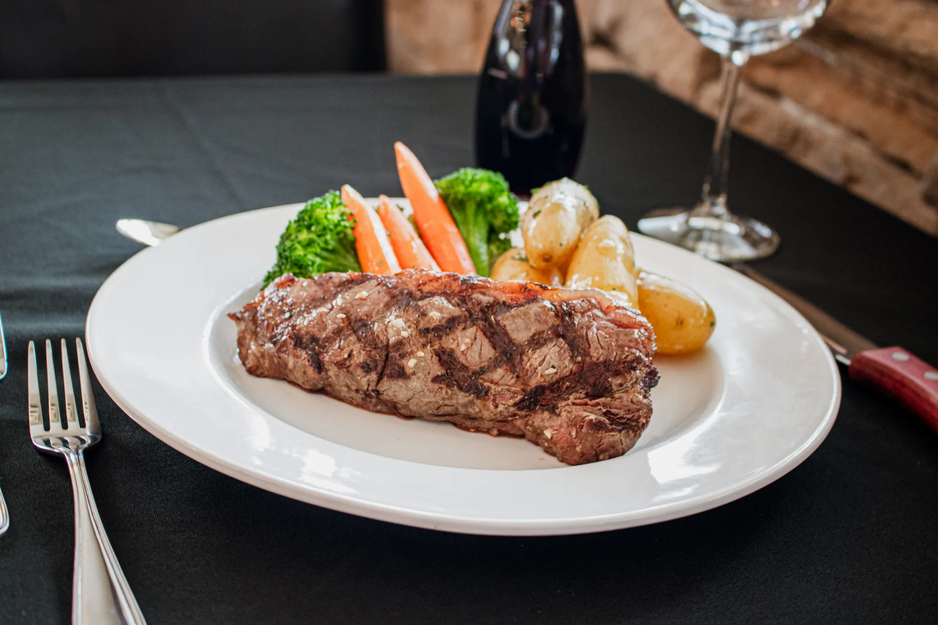 Bison Striploin Steak served with seasonal vegetables